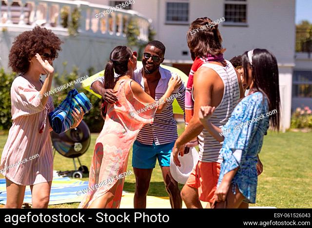 Diverse group of friends greeting each other at a pool party