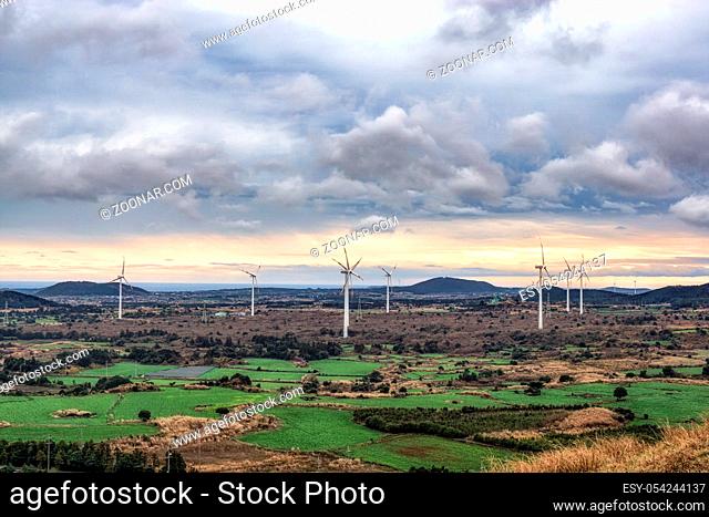 The view of wind turbines taken from Yongnuni Oreum during winter. Yongnuni Oreum is a famous volcanic crater in Jeju island, South Korea