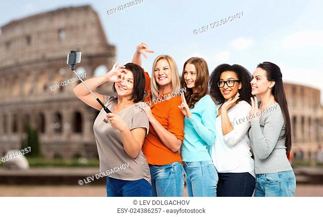 friendship, technology, travel, tourism and people concept - group of happy different size women in casual clothes taking picture with smartphoone on selfie...