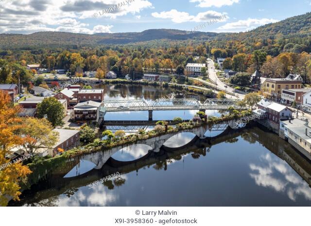 The Bridge of Flowers spans the Deerfield River with the rolling hills of Western Massachusetts as a backdrop in Shelburne, MA during fall