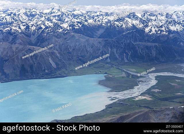 aerial, from a glider, of Hopkins river entering lake Ohau north shore, shot in bright spring light from above Ben Ohau range, Canterbury, South Island