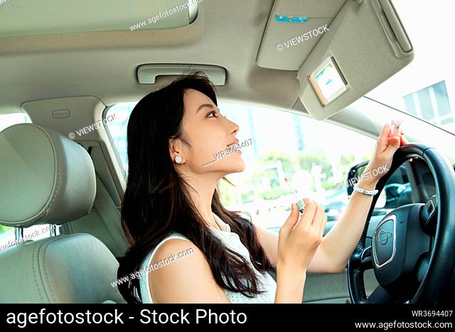 Young women makeup in the car