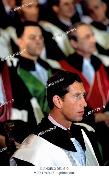 Charles of Wales sitting in an audience, dressing a gown. The Prince of Wales in gown, during the ceremony for honorary degree by the University of Bologna