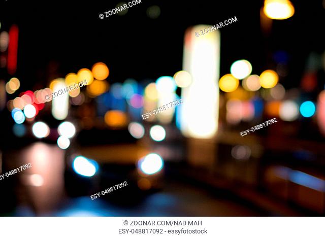 blurred view of taxi car at night - street scene , city lights at night