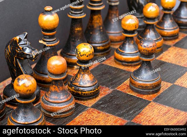 black chess pieces line with one pawn started