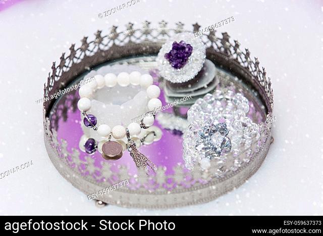Beautiful set of bridal accessories made from natural stones. Rock crystal and agate ring and earrings. Copy space