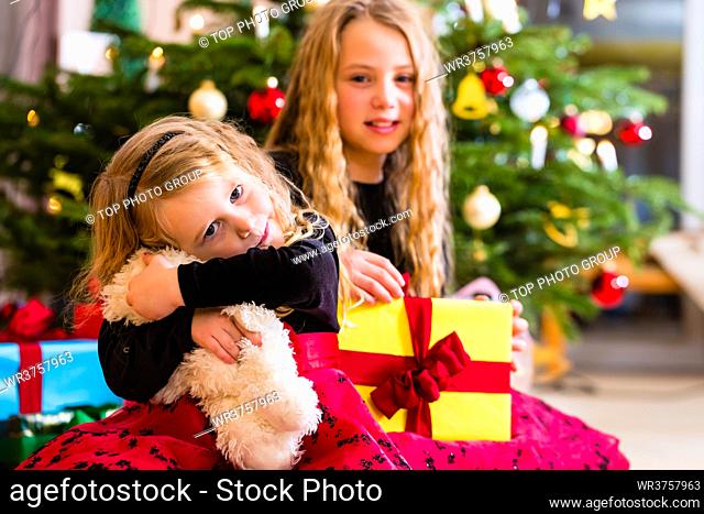 Children receiving presents on Christmas day