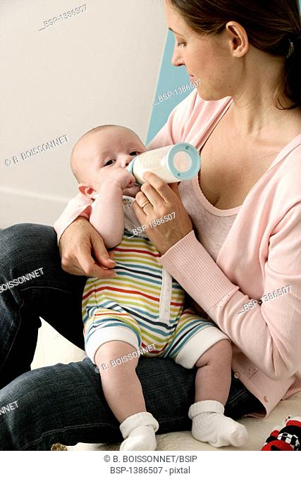 INFANT DRINKING FROM BABY BOTTLE Models. 3-month-old baby boy