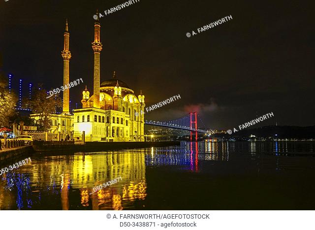 Istanbul, Turkey The Ortakoy Mosque under the Bosphorus Bridge, known officially as the 15 July Martyrs Bridge and unofficially as the First Bridge