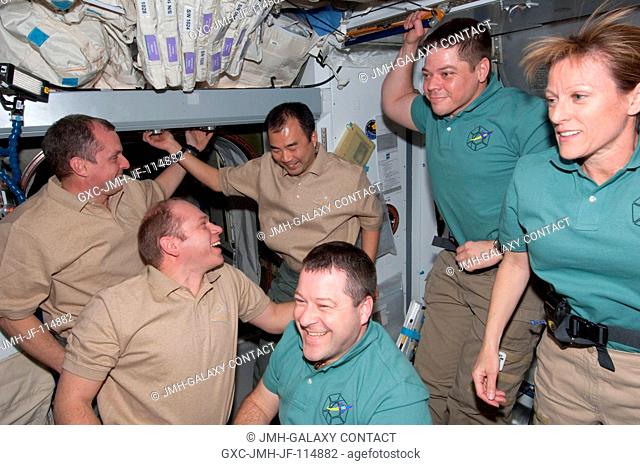 The STS-130 and Expedition 22 crew members gather for a farewell ceremony in the Harmony node of the International Space Station