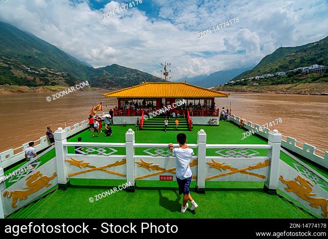 Yangtze River, China - August 2019 : Yangtze River, China - August 2019 : Tourist standing on the viewing platform on the top deck of the luxury passenger...