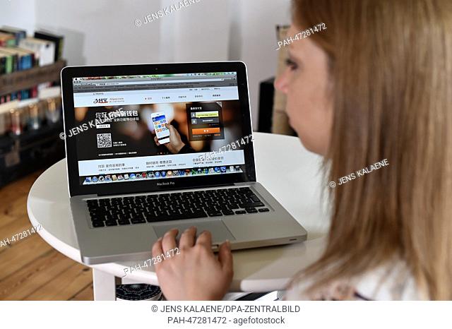 ILLUSTRATION - A young woman browses on her notebook computer through the web page of Chinese online money transfer and payment service provider Alipay in...