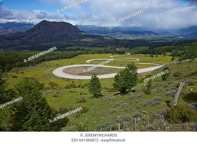 The Carretera Austral; famous road connecting remote towns and villages in northern Patagonia, Chile. Curved section running through farmland near the small...