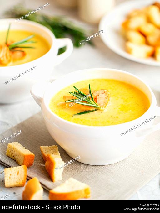 Fish cream soup with Salmon, cheese, Potatoes and herbs in white Soup Bowls