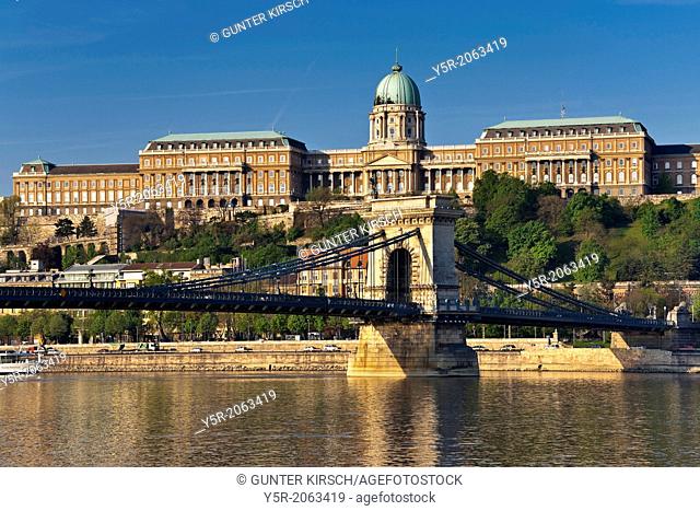 View over Danube river to Szechenyi Chain Bridge and Buda Castle on Castle Hill in the Castle District, Budapest, Hungary, Europe