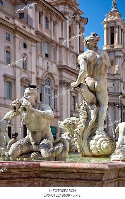 Fontana del Moro, Piazza Navona, with church of Sant'Agnese in Agone beyond, on sunny summer day