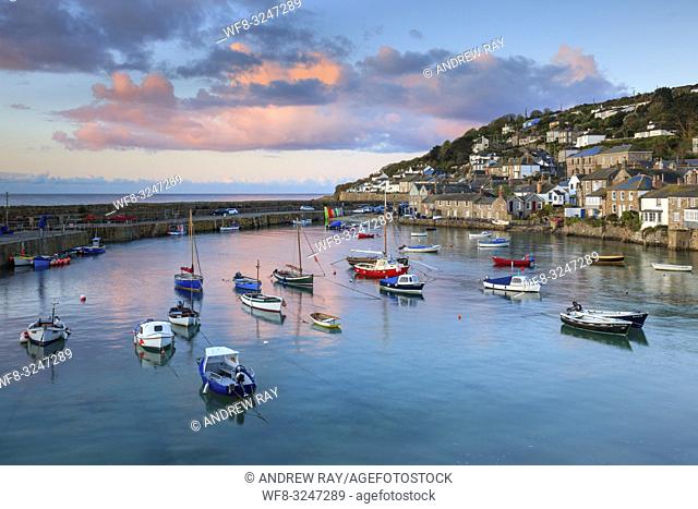The picturesque harbour at Mousehole on the western side of Mount's Bay in Cornwall. The image was captured at sunrise on a still morning in late April