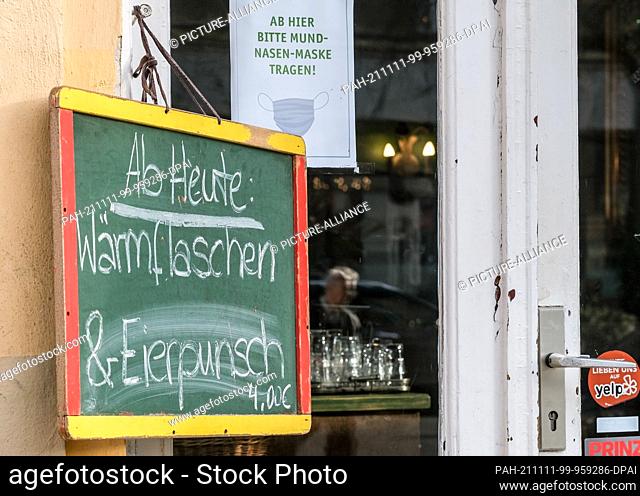 11 November 2021, Berlin: Against the cool temperatures in November, a restaurant in Pankow offers its guests ""From today: hot water bottles and eggnog"" and...