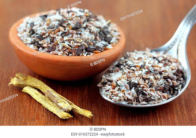 Medicinal herbs isabgul, basil seeds and yastimadhu on a wooden surface