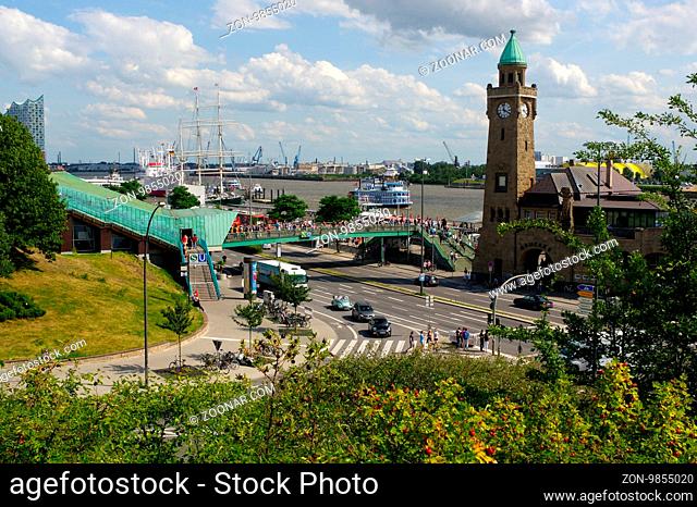 HAMBURG, GERMANY - JULY 18, 2016: a Beautiful view of famous Landungsbruecken with commercial harbor and Elbe river with blue sky and clouds in summer, St