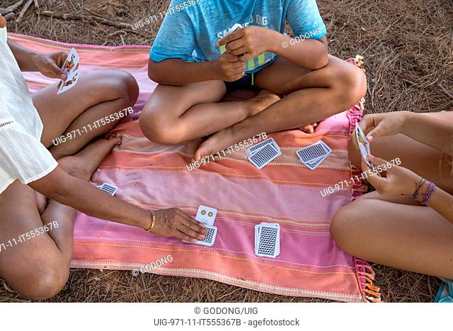Vacationers playing cards in Salento, Italy