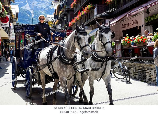 Horse-drawn carriage in Zermatter Bahnhofstraße street, Zermatt, Canton of Valais, Switzerland