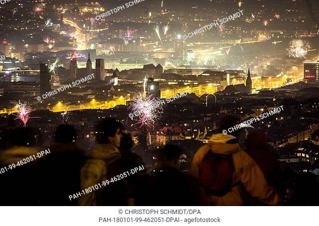 After burning up large quantities of fireworks during the celebrations of New Year's Eve, a dense veil of smoke lies over Stuttgart, Germany, 01 January 2018