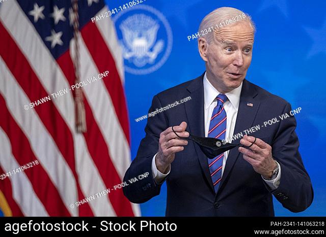 US President Joe Biden responds to a question from the news media following an event to mark Equal Pay Day in the State Dining Room of the White House in...