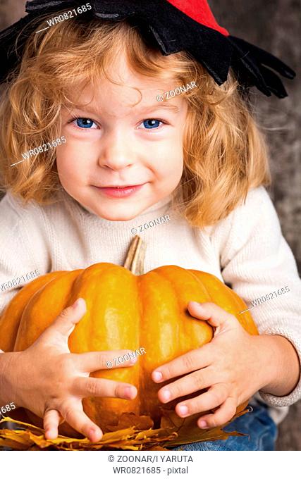 Child with big pumpkin