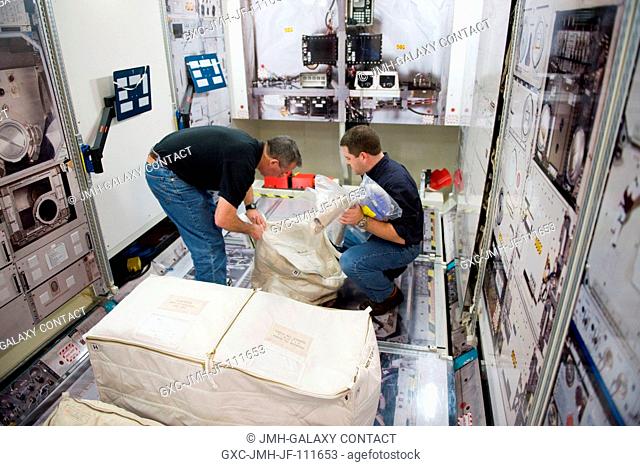 Astronauts Stephen Robinson (left) and Nicholas Patrick, both STS-130 mission specialists, participate in a training session in an International Space Station...