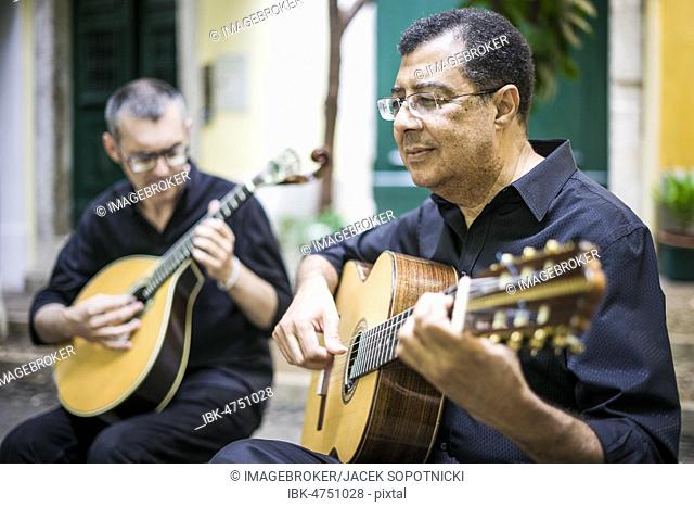 Two fado guitarists with acoustic and portuguese guitars in Alfama, Lisbon, Portugal, Europe