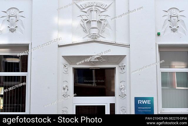 28 April 2021, North Rhine-Westphalia, Essen: A miner's lamp framed by two pitons and the miner's greeting ""Glück Auf"" can be seen on the façade of an old...