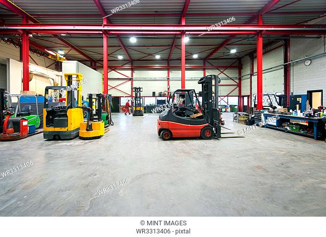 Forklift machinery working in warehouse