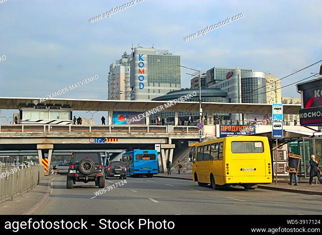 Kyiv, Ukraine - 15 OCTOBER, 2019: Traffic on modern city street. Contemporary train riding on railroad bridge over road with cars in center of capital