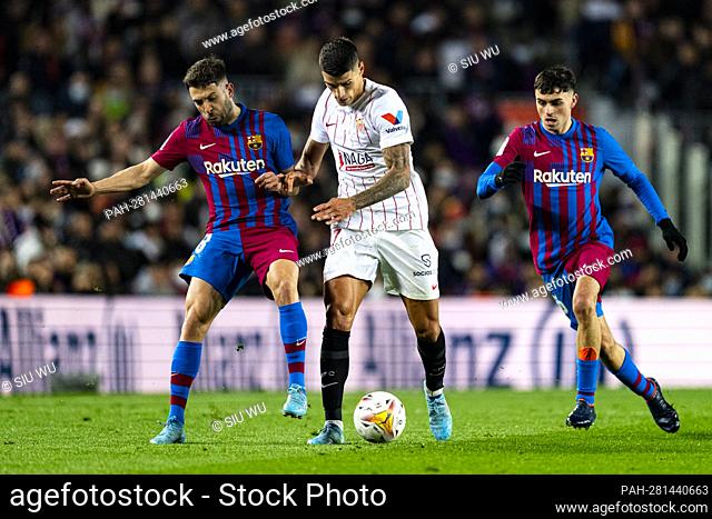 Lamela (Sevilla FC) duels for the ball against Jordi Alba (FC Barcelona) and Pedri (FC Barcelona) during La Liga football match between FC Barcelona and Sevilla...