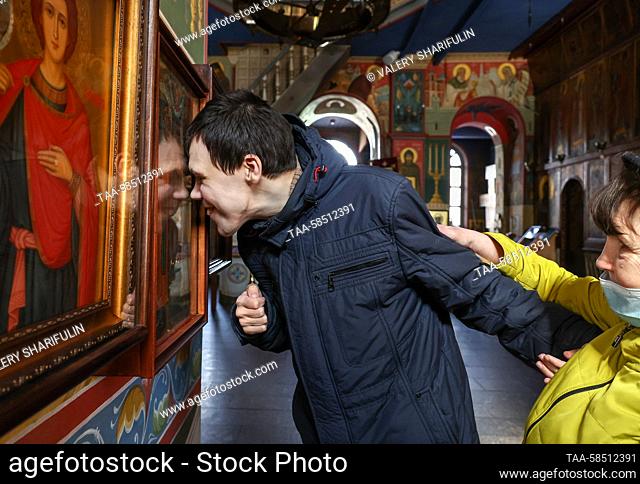 RUSSIA, MOSCOW - MARCH 23, 2023: Special People's House care recipient Sergei (C) and his mother are seen in the Church of the Kazan Icon of Virgin Mary in...