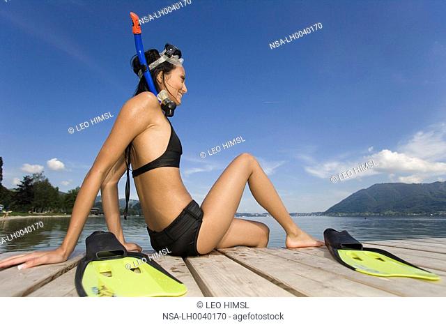 woman with snorkelling equipment at the lake