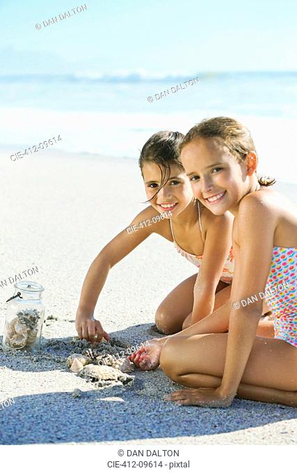 Girls playing in sand on beach