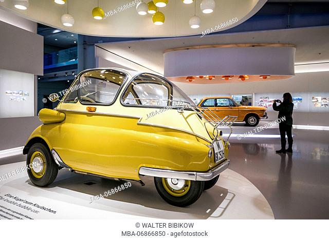 Germany, Bavaria, Munich, BMW Museum, 1955 BMW Isetta bubble car with photographer