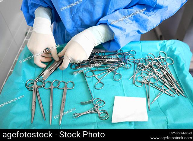 Multiple surgery instruments on blue table above view. surgeon take surgical tools from table. High quality photography