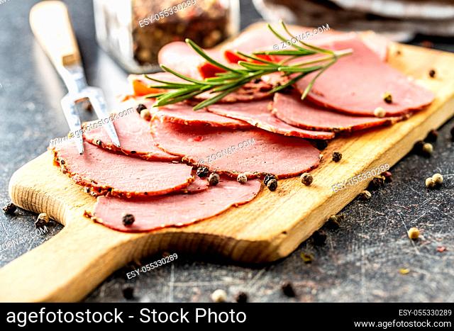Sliced roast beef. Tasty fresh meat on cutting board