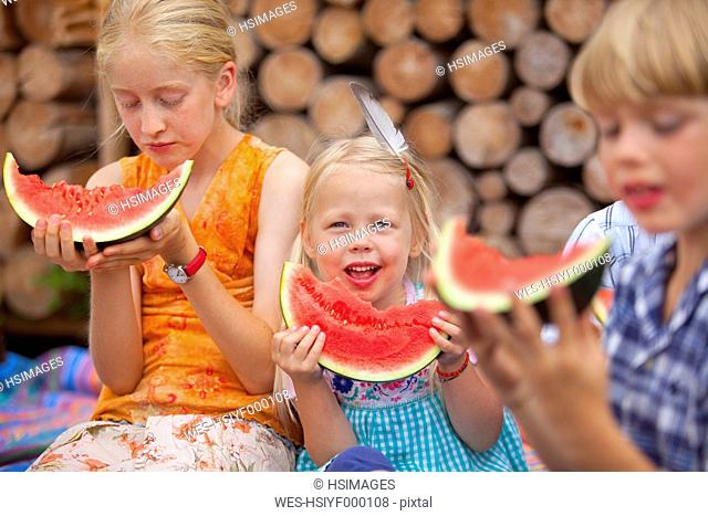 Germany, Bavaria, Group of children eating watermelon