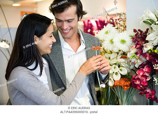 Couple looking at artificial flowers together