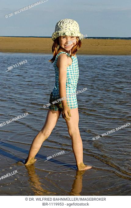 Girl with sunhat on the beach, waterfront, seaside of the Adria, Bibione, Venetia, Venice, Italy, Europe
