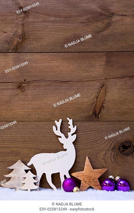 Vertical Christmas Card With White And Purple Christmas Decoration On Snow. Copy Space For Advertisement. Decoration Like Balls, Tree, Star And Reindeer