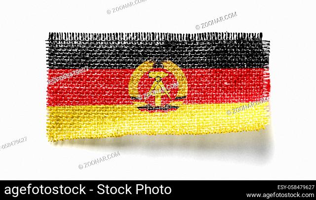 GDR flag on a piece of cloth on a white background