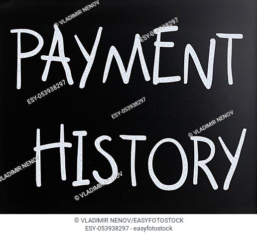 """""Payment history"" handwritten with white chalk on a blackboard