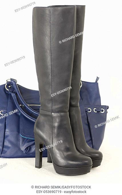 fashionable black boots with a handbag