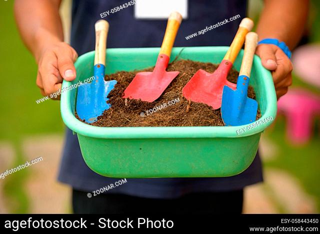 Portrait of gardening shovel on bucket of dirt