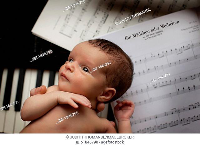 Newborn baby, two weeks, piano, sheet music